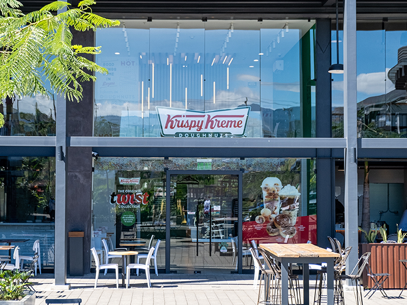 Krispy Kreme - Glass storefront design with outdoor seating and prominent signage - Contract Workplaces.jpg